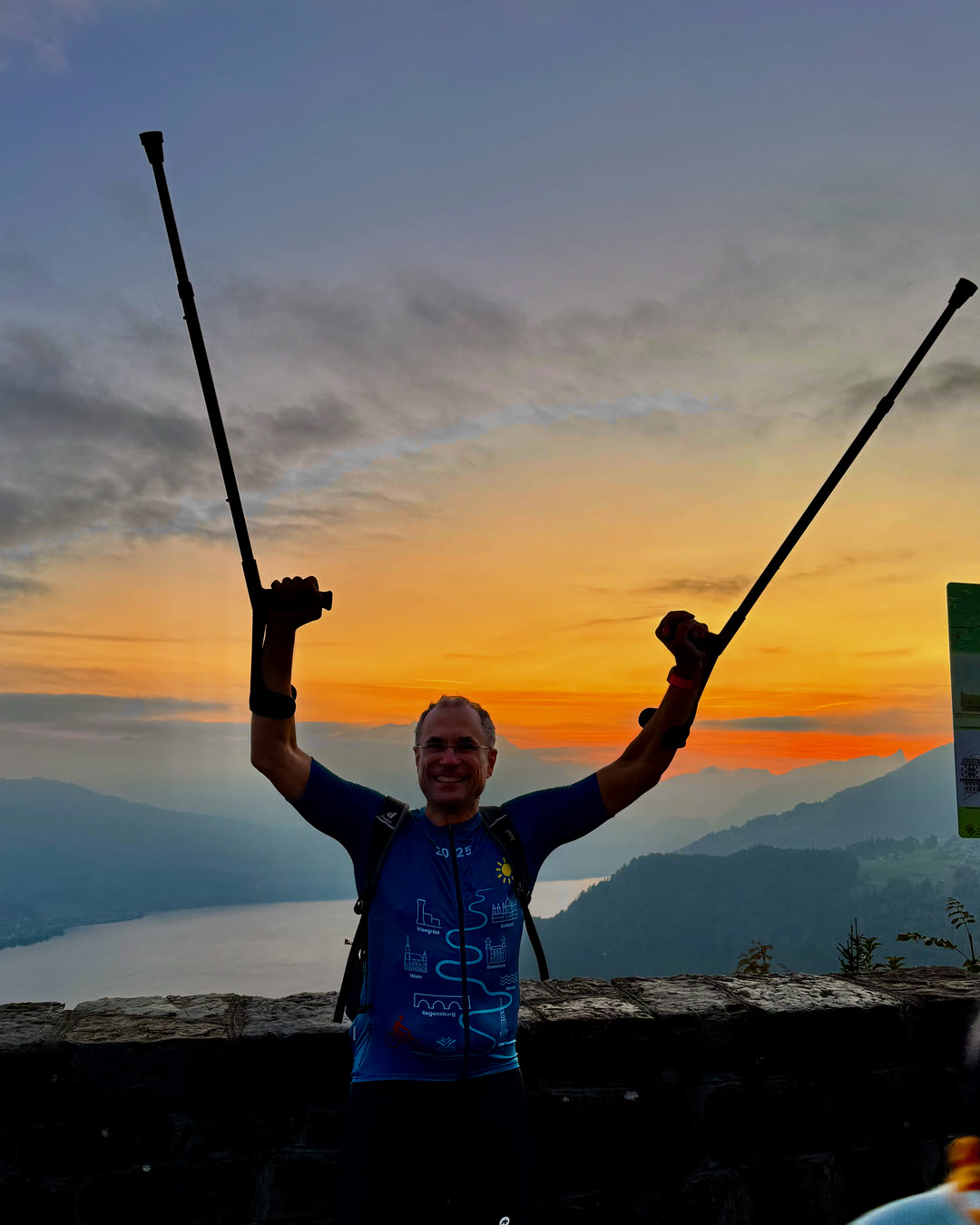At the Harderkulm summit at sunset, poles raised